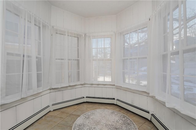 unfurnished sunroom with a baseboard heating unit