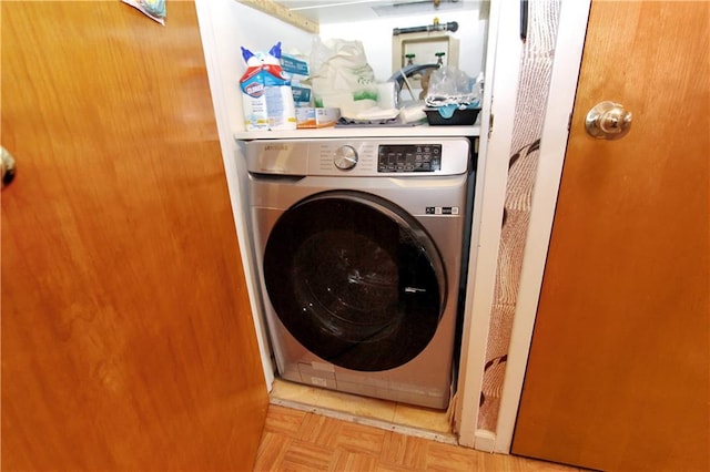 clothes washing area featuring washer / dryer and laundry area