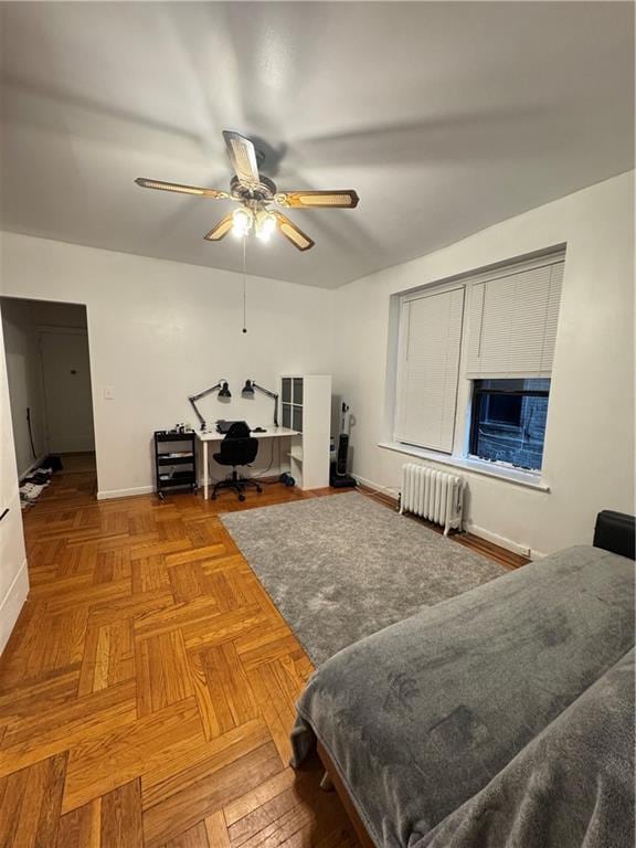 living room featuring parquet floors, radiator heating unit, and ceiling fan