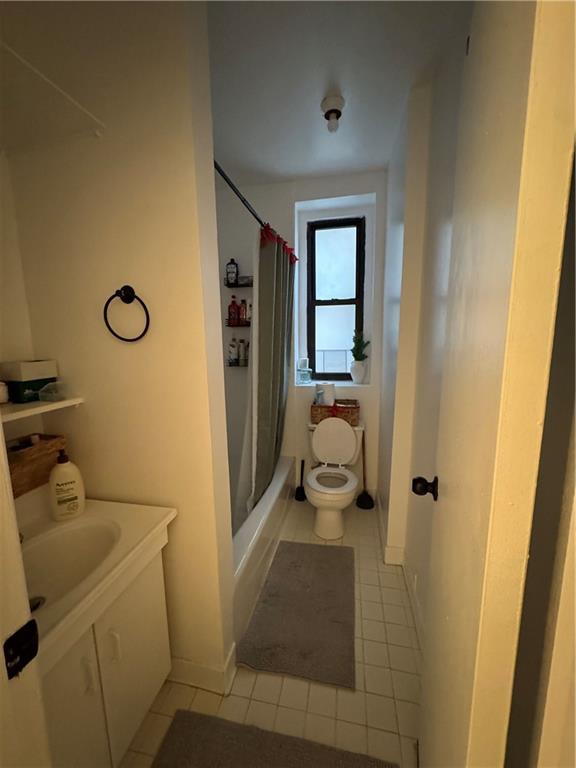 bathroom featuring tile patterned floors, toilet, and shower / tub combo