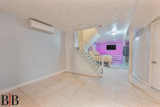 interior space featuring tile patterned flooring and an AC wall unit