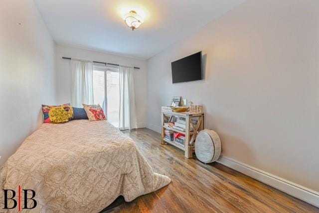 bedroom with hardwood / wood-style flooring