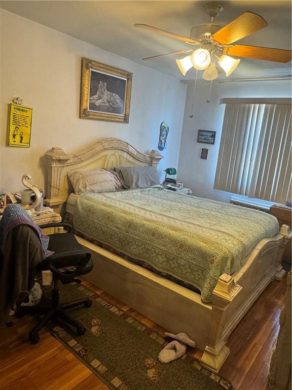 bedroom with hardwood / wood-style flooring and ceiling fan