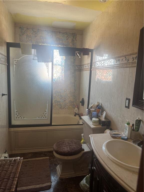 full bathroom with enclosed tub / shower combo, vanity, toilet, and tile patterned floors