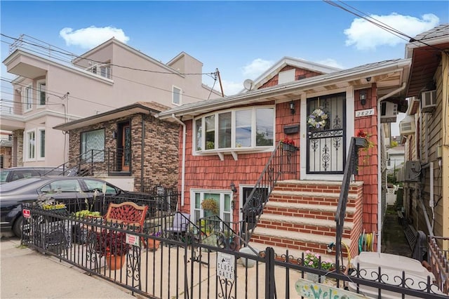 view of front of house featuring a fenced front yard and brick siding