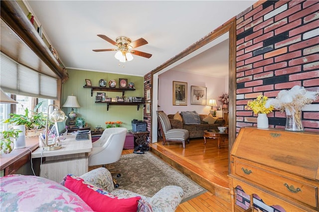 interior space with ceiling fan, hardwood / wood-style floors, and crown molding