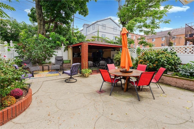 view of patio with outdoor dining space and a fenced backyard