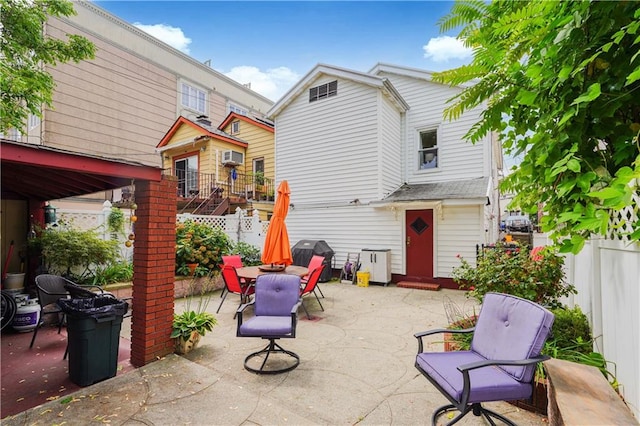 view of patio with a grill and fence