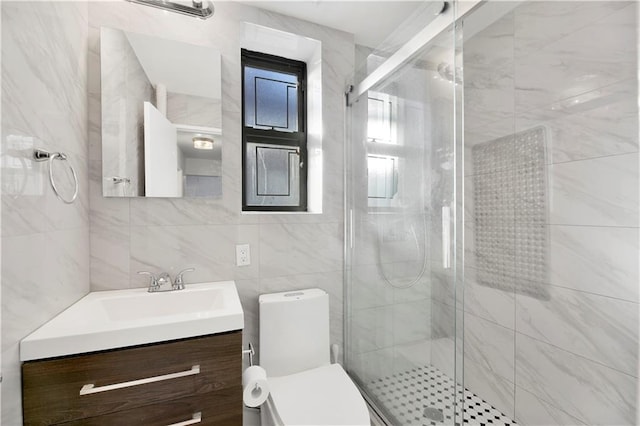 bathroom with vanity, tile walls, an enclosed shower, and toilet