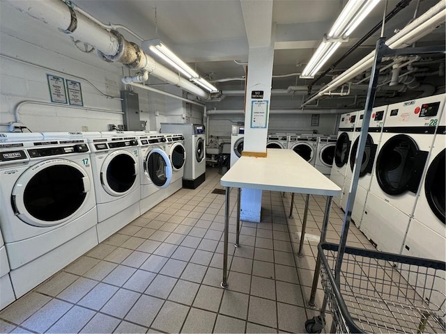 community laundry room with tile patterned floors and washer and dryer