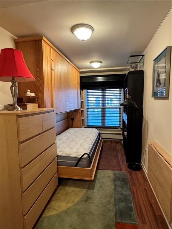 bedroom featuring baseboards and dark wood-style floors