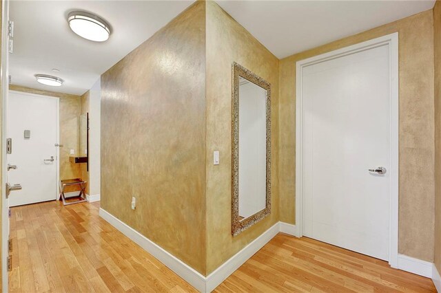 hallway with hardwood / wood-style floors