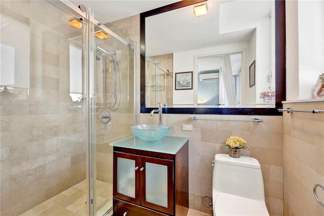 bathroom featuring vanity, toilet, a shower with shower door, and tile walls