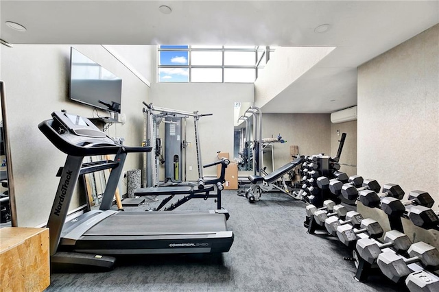 workout area featuring a wall mounted air conditioner