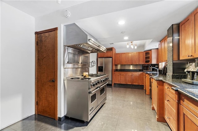 kitchen featuring dark stone countertops, appliances with stainless steel finishes, sink, and exhaust hood