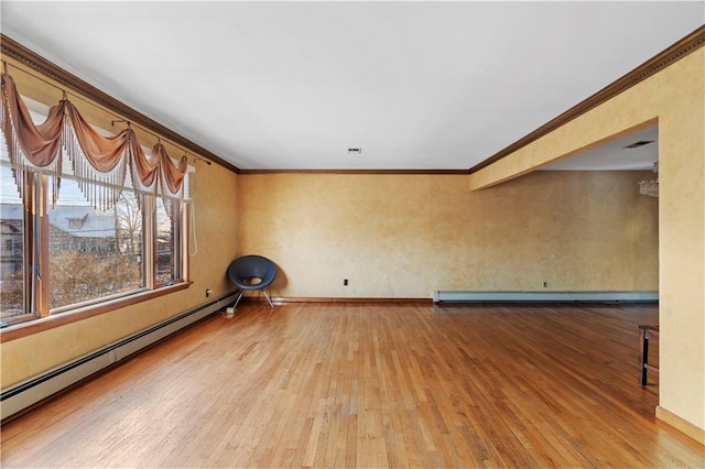 unfurnished room featuring ornamental molding, wood-type flooring, and baseboard heating