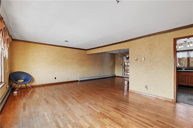 unfurnished room featuring crown molding, light hardwood / wood-style flooring, and a baseboard heating unit