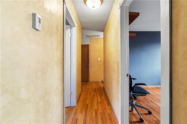 corridor featuring vaulted ceiling and light wood-type flooring