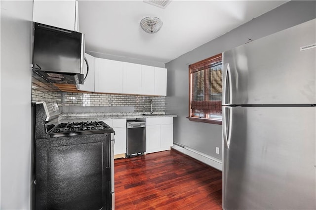 kitchen featuring white cabinetry, stainless steel appliances, dark hardwood / wood-style flooring, and backsplash