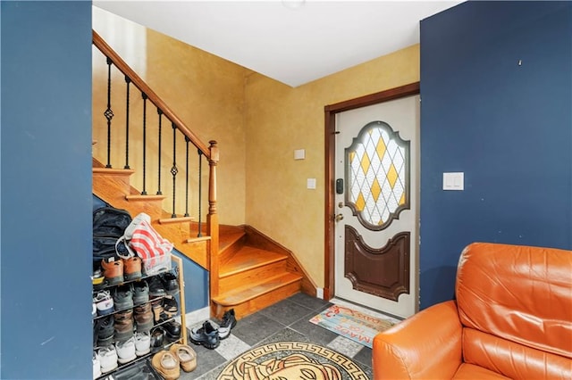 entrance foyer featuring dark tile patterned floors