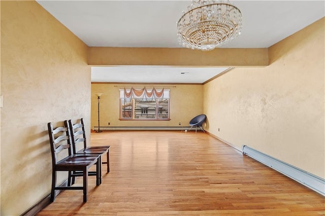 interior space featuring a chandelier, light wood-type flooring, and baseboard heating