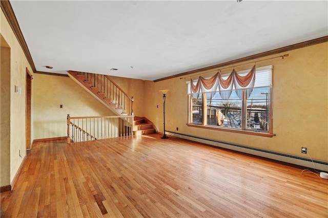 unfurnished living room featuring hardwood / wood-style flooring, crown molding, and baseboard heating