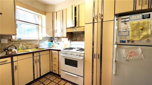 4400 Bedford Ave, Brooklyn, NY 11229 - kitchen with white appliances, tasteful backsplash, custom exhaust hood, and cream cabinetry