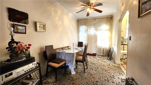 4400 Bedford Ave, Brooklyn, NY 11229 - dining room with crown molding, arched walkways, ceiling fan, and baseboards