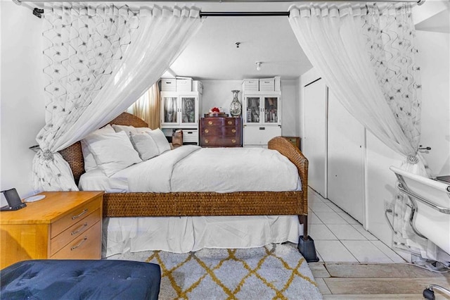 bedroom featuring a closet and light tile patterned floors