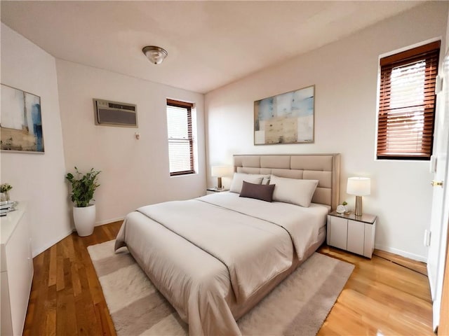 680 81st St Unit 3B, Brooklyn, NY 11228 - bedroom featuring an AC wall unit, light wood-type flooring, and baseboards