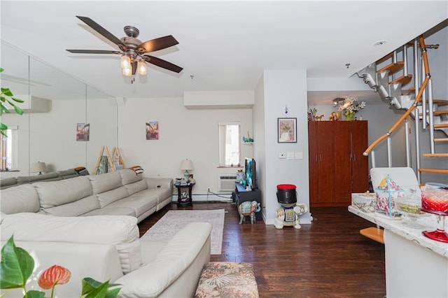 living area with stairway, an AC wall unit, a ceiling fan, and wood finished floors