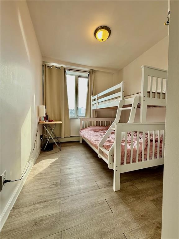 bedroom with hardwood / wood-style floors