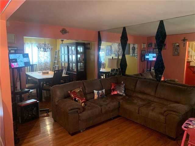 living room with a chandelier and wood finished floors