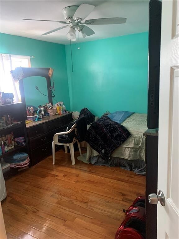 bedroom featuring wood-type flooring and ceiling fan