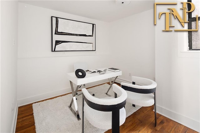 home office featuring baseboards and wood finished floors