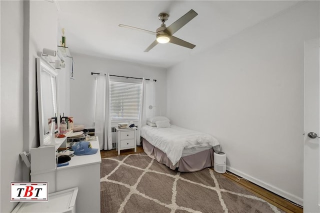 bedroom featuring ceiling fan, baseboards, and wood finished floors