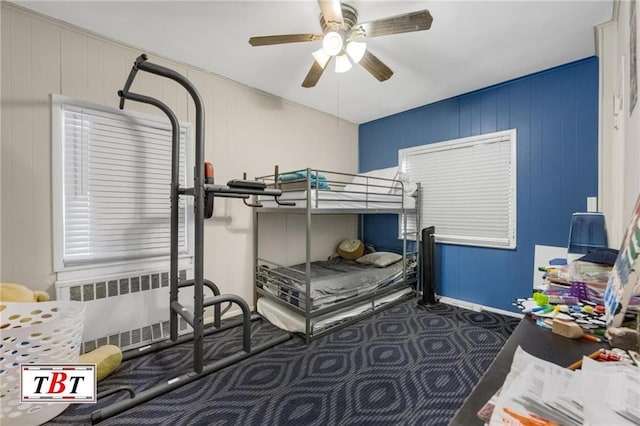 bedroom with radiator heating unit and a ceiling fan