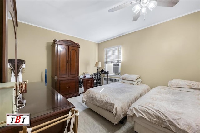 bedroom with a ceiling fan, cooling unit, crown molding, light colored carpet, and radiator heating unit