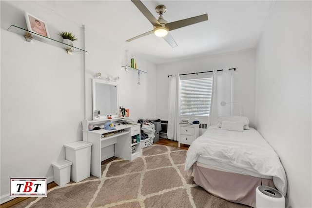 bedroom featuring wood finished floors and ceiling fan