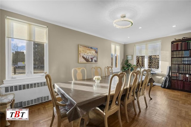 dining space featuring baseboards, radiator heating unit, recessed lighting, and a healthy amount of sunlight