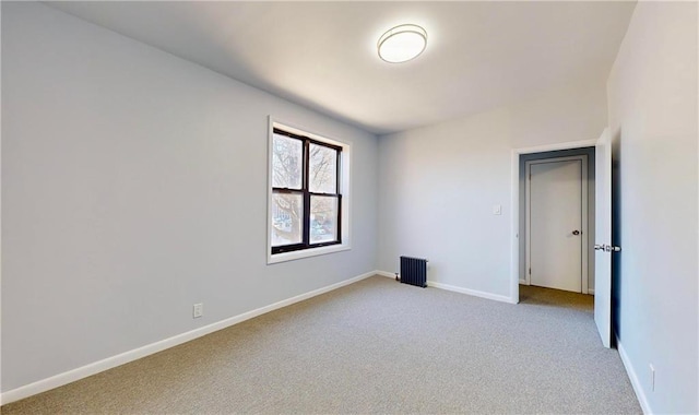 unfurnished bedroom with baseboards, light carpet, and radiator heating unit