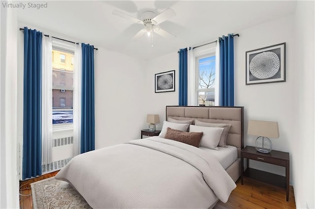 bedroom with a ceiling fan and wood finished floors