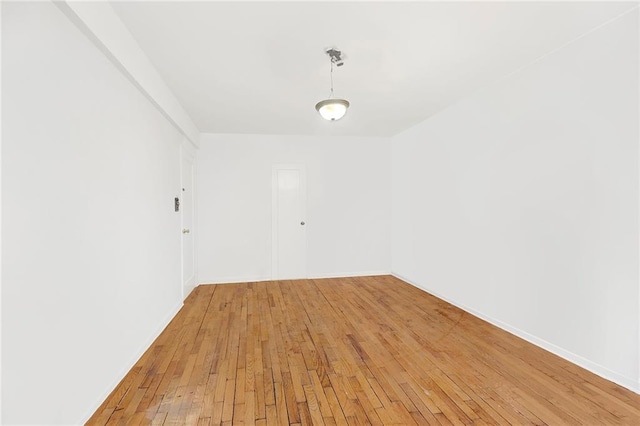 unfurnished room with hardwood / wood-style flooring