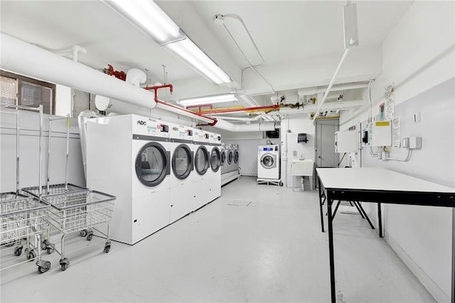 washroom with sink and washing machine and clothes dryer