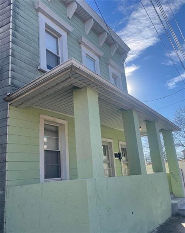 view of property exterior featuring covered porch