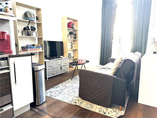 living room with dark hardwood / wood-style flooring