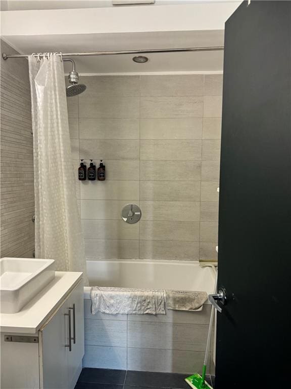 bathroom featuring sink and shower / bath combo with shower curtain