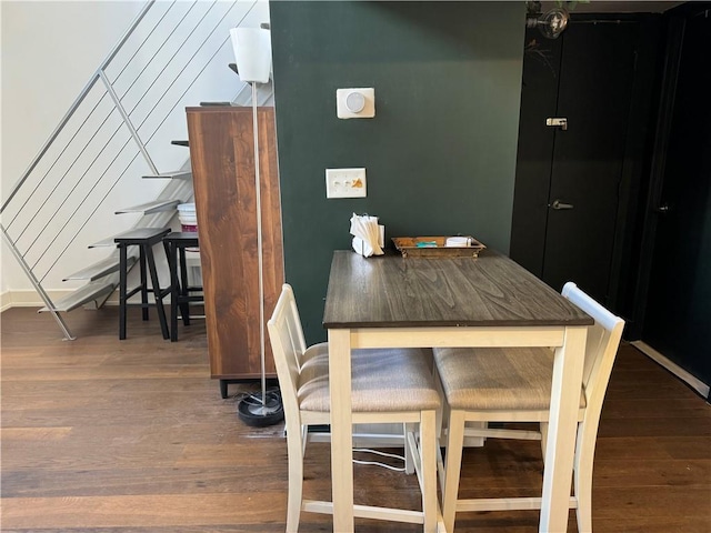 dining space with dark hardwood / wood-style floors