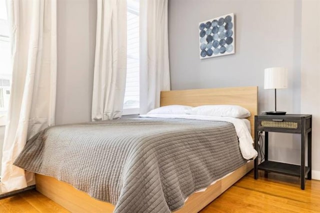 bedroom with wood-type flooring