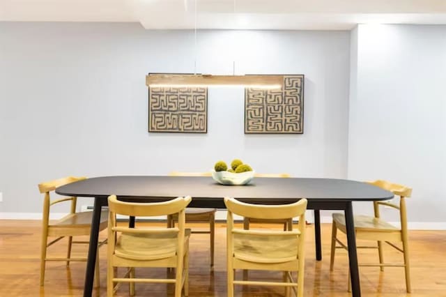 dining room featuring breakfast area and hardwood / wood-style flooring